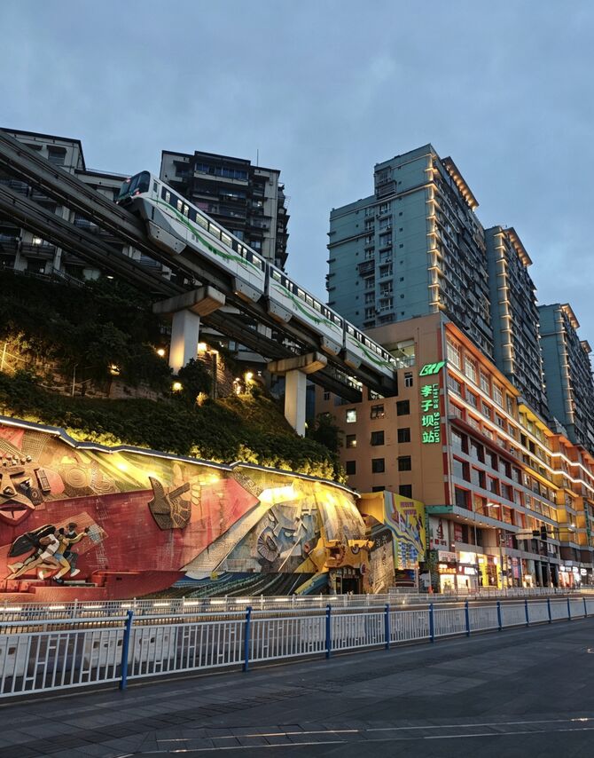 Liziba Station — the Chongqing Line 2 monorail passing through floors 6-8 of the Liziba Mansion residential building, photographed from the street-level viewing platform.