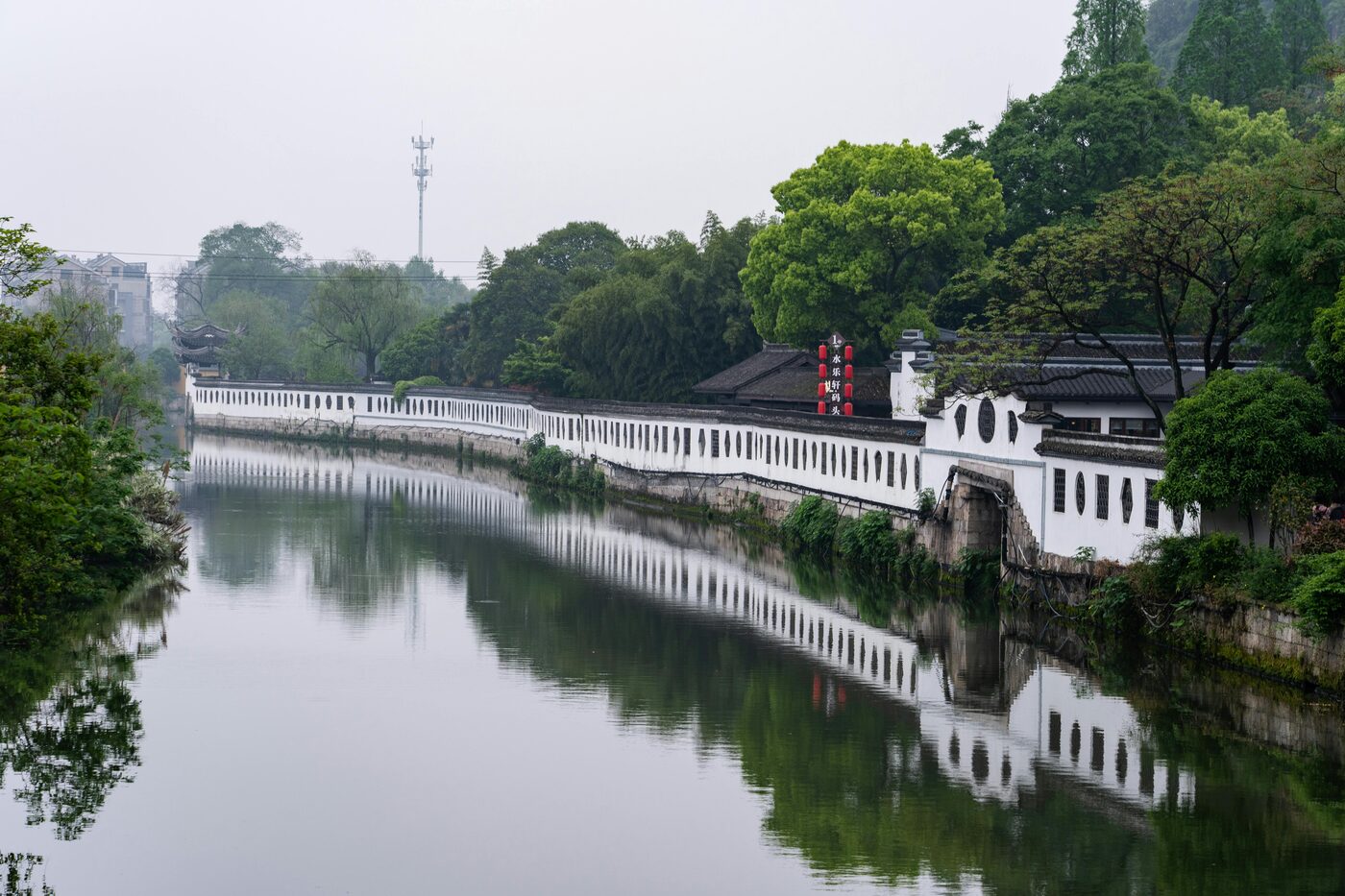 The Grand Canal in Hangzhou by the triple-arched Gongchen Bridge, with the restored Qiaoxi historic warehouse district along the water.