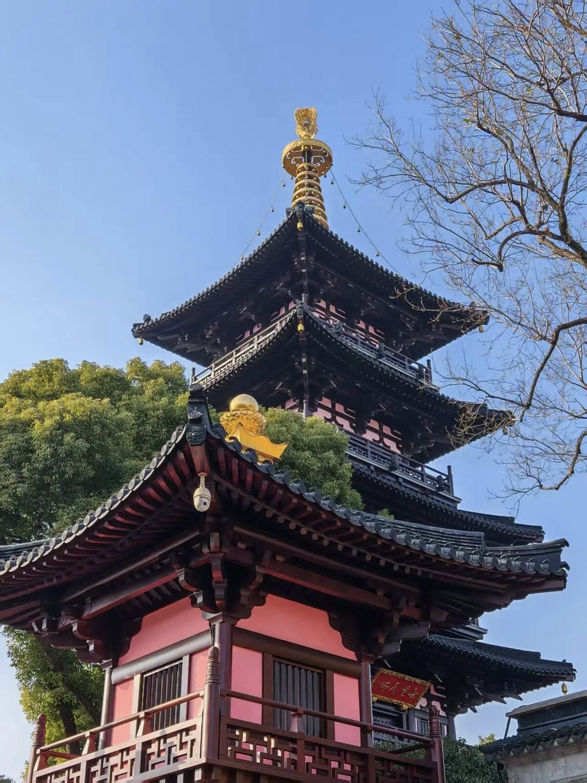 The yellow walls and roofs of Hanshan Temple beside the Grand Canal and Maple Bridge in Suzhou.