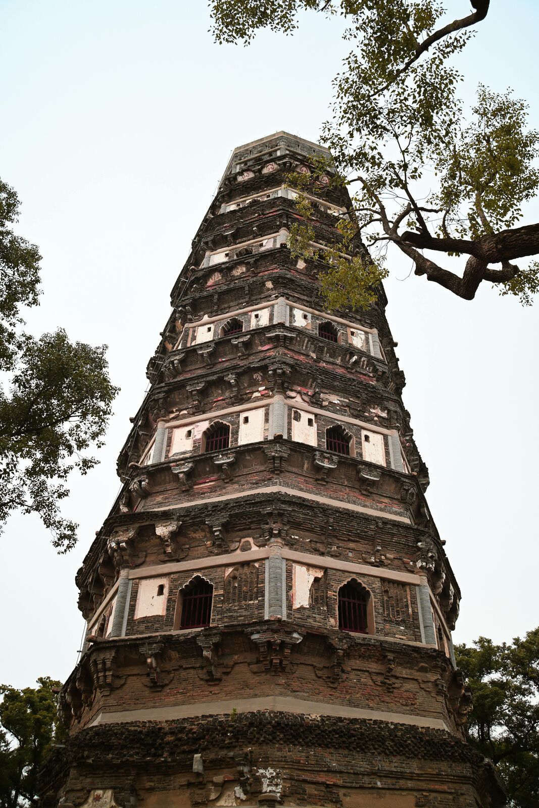 The leaning Yunyan Pagoda on the wooded summit of Tiger Hill in Suzhou.