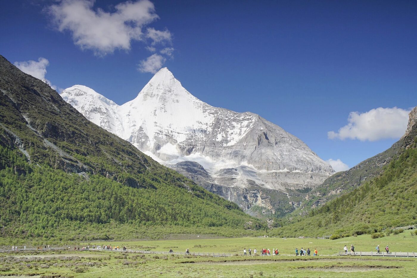 Snow peaks, alpine meadow and a clear lake at Daocheng Yading, western Sichuan.