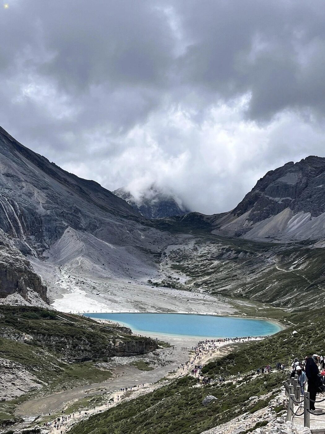 A Tibetan village and monastery below snow mountains in the Daocheng valley.
