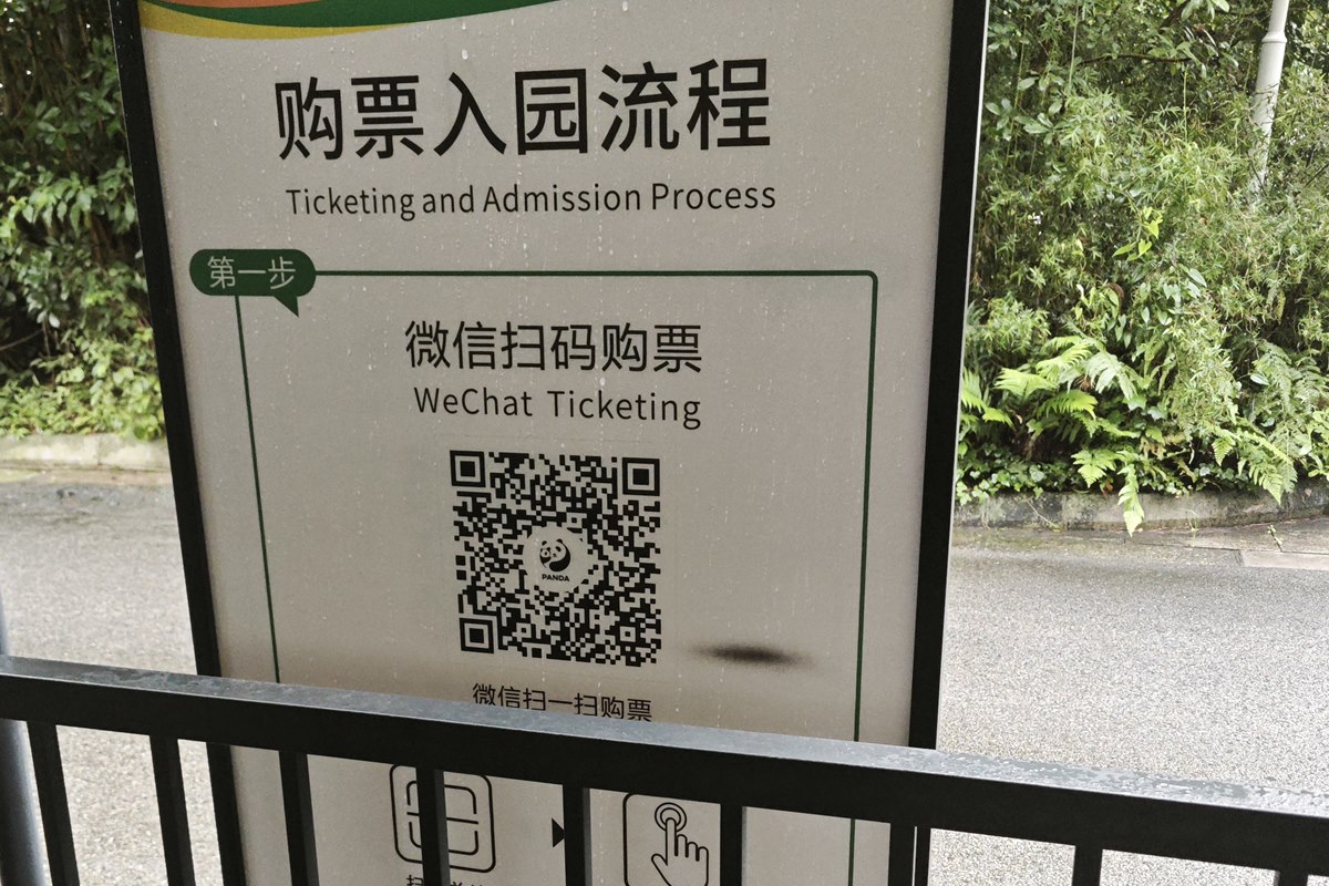 Bilingual board at the Panda Valley entrance headed Ticketing and Admission Process, step one being WeChat ticketing by QR code.