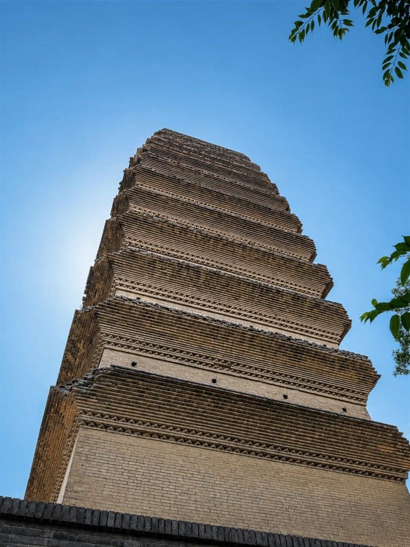 Looking up the Small Wild Goose Pagoda, showing about ten tightly stacked eave tiers of corbelled brick converging towards the top.
