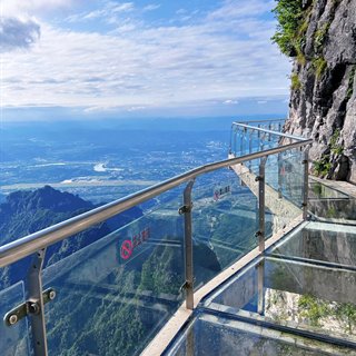 The west-line glass skywalk on the cliff edge of Tianmen Mountain, looking over the city.