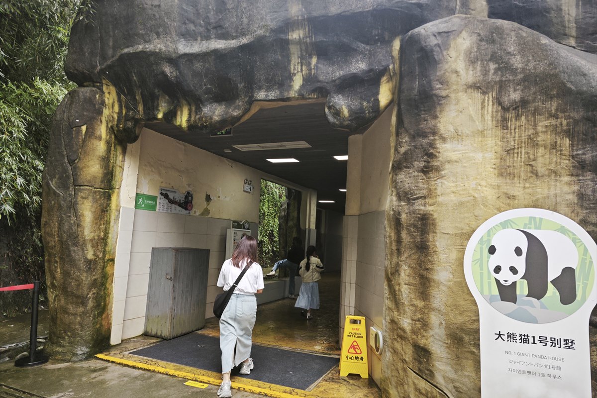The rock-cut entrance to No. 1 Giant Panda House at Panda Valley, its sign in Chinese, English, Japanese and Korean.